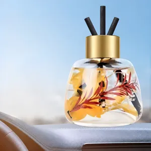 Car reed diffuser bottle with essential oil and dried flowers for long-lasting fragrance.