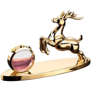 Golden deer car perfume ornament with a pink liquid bottle on oval base, elegant interior decor.