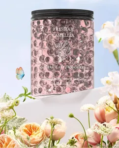 Detailed close-up of pink aromatherapy crystal beads jar with fresh floral decor for home fragrance.