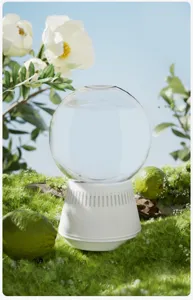 Inverted aroma diffuser detail view showing the clear glass sphere and white base in setup.