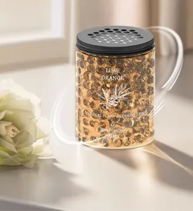 Closeup of aromatic air freshener deodorant beads jar with perforated lid and label details.