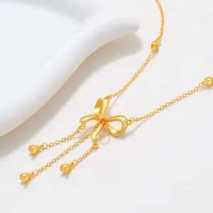 Gold-plated tassel bow necklace detail, elegant clavicle chain, chic female jewelry.
