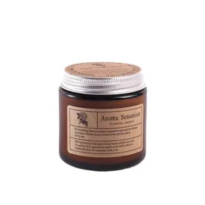 Amber glass jar scented soy candle for home relaxation, long lasting aromatherapy fragrance.