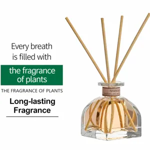 Glass aromatherapy diffuser bottle with reed sticks for home interior air freshener and room scent.
