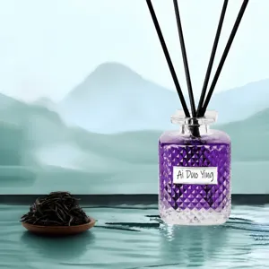 Home aromatherapy diffuser with purple glass bottle and reed sticks for lasting fragrance.