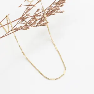 Close-up detail shot of a simple gold-colored stainless steel plain chain necklace for daily wear.