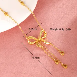 Gold plated copper alloy bow tassel necklace detailed view, elegant clavicle chain for women.