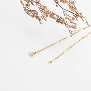 Stainless steel gold necklace chain detail shot, delicate link design with secure clasp.
