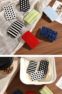 Chic dopamine acetate hair clip set featuring trendy black and white polka dots and stripes.