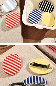 Oval acetate hair clips with stylish striped and solid color designs for sweet styling.