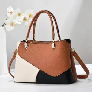 Vue détaillée du sac à main élégant color-block avec empiècements marron, blanc et noir.