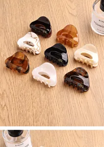 Small triangle acetate hair claw clip, elegant minimalist half-up hairstyle accessory for women.