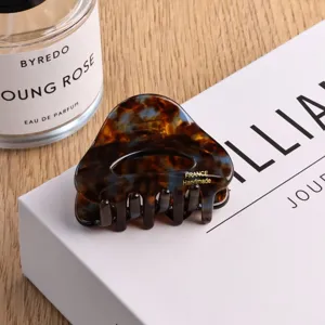 Small triangular acetate hair claw clip, tortoise shell pattern, elegant back hair accessory.