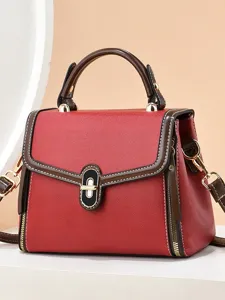 Élégant sac à main en cuir rouge pour femme avec bordure marron et bandoulière chic