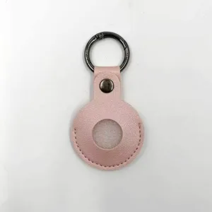 Pink leather protective case detail for tracking device, featuring a durable metal keyring and snap.