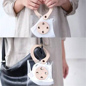 Portable clear PVC mask storage bag with leather trim and hanging strap for daily use.