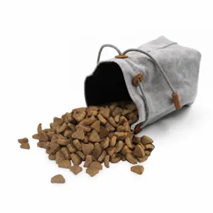 Canvas pet treat pouch detail view, portable drawstring storage bag for outdoor feeding.