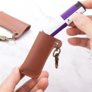 Vintage leather lighter sleeve detail, retro protective case with metal keyring, portable.