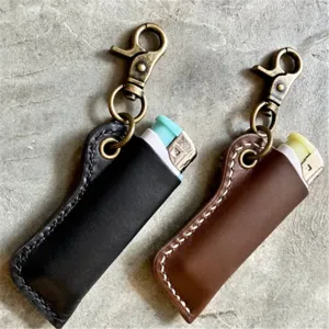Detailed view of vintage leather lighter sleeve with metal keychain, premium texture and stitching.