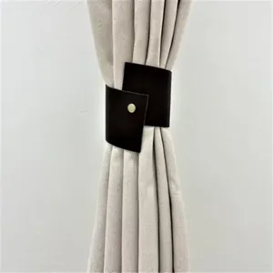 Minimalist dark brown PU leather curtain tieback buckle for modern home window decor.