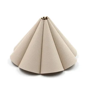 Close-up detail of beige leather camping lampshade, premium texture folding flower design.