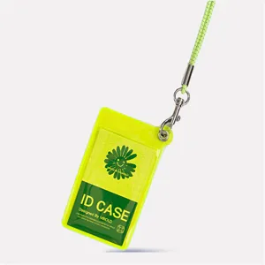 Detailed view of clear PVC ID card holder with green lanyard and smiling flower design.