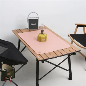 Detailed view of the pink leather camping mat showing its texture and surface details.