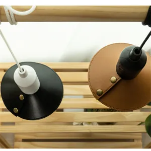 Outdoor camping leather lampshade detail view with metal snap buttons and vintage style.