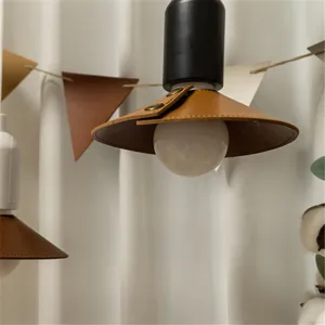 Detailed close-up of outdoor camping leather lampshade with metal snaps, vintage aesthetic.