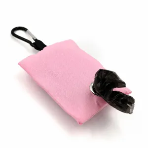 Canvas dog waste bag holder detail, pink portable pet poop bag dispenser with carabiner clip.