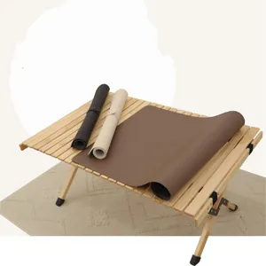 Rollable leather desk mat detail showing smooth surface texture and neat edge stitching.