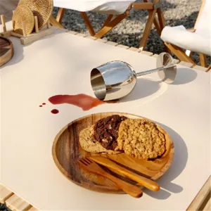 Detail shot of waterproof leather picnic mat for outdoor camping table, beige surface styling.