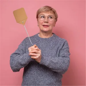 Detail view showing the classic perforated fly swatter with a durable twisted wire handle.