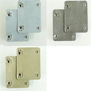 Leather luggage handle wrap detail showing durable material and cute paw metal snap design.