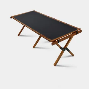 Outdoor folding wooden camping table with roll-up black leather mat for picnic hiking.