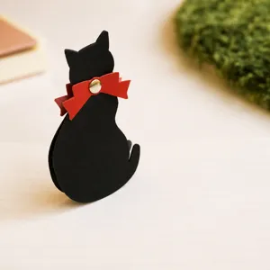 Leather cat bookmark close-up shot, featuring a cute black cat silhouette with a red bow.