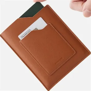Leather passport holder detail shot showing card slot and brown texture finish.