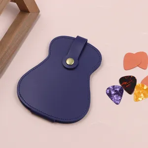 Detail view of the leather guitar pick case, showing gourd shape, snap button and vibrant colors.