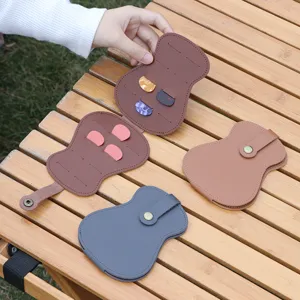 Detailed view of leather guitar pick storage pouch, portable gourd shape case accessory.