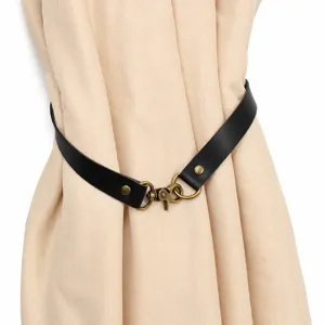 Minimalist black leather curtain tieback with retro brass metal clasp, elegant home decor strap.