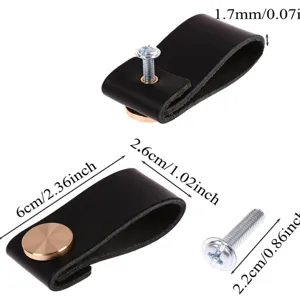 Black leather cabinet pull handle with metal screw, modern furniture hardware detail view.