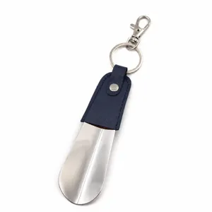 Detail view of the portable metal shoehorn keychain with premium leather wrapped handle.
