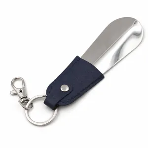 Portable mini metal shoe horn with leather wrap and key ring for travel daily use.