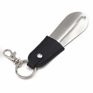 Portable metal shoehorn with black leather sleeve keychain, short shoe helper tool for daily use.