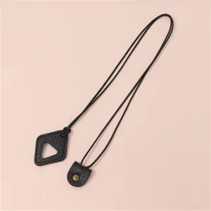 Close up detail of black leather sunglasses strap lanyard with triangle pendant and metal snap.