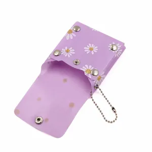 Portable translucent PVC lipstick storage pouch with daisy print and metal snap button.