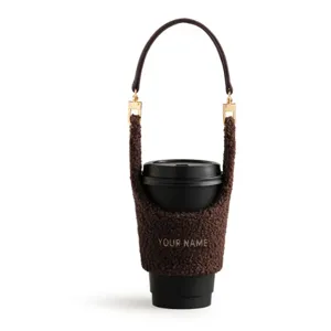 Cozy teddy fleece coffee cup sleeve with leather handle and custom text detail for winter hot drinks.