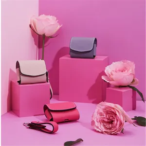 Close-up detail shot of pastel wireless earphone PU leather protective cases with fine stitching.