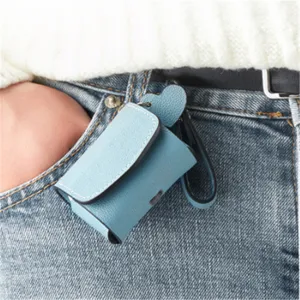 Detailed view of blue PU leather wireless earphone case hanging on jeans pocket securely.
