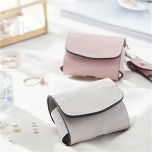 Detail shot of minimalist PU leather wireless earphone case in elegant lifestyle setting
